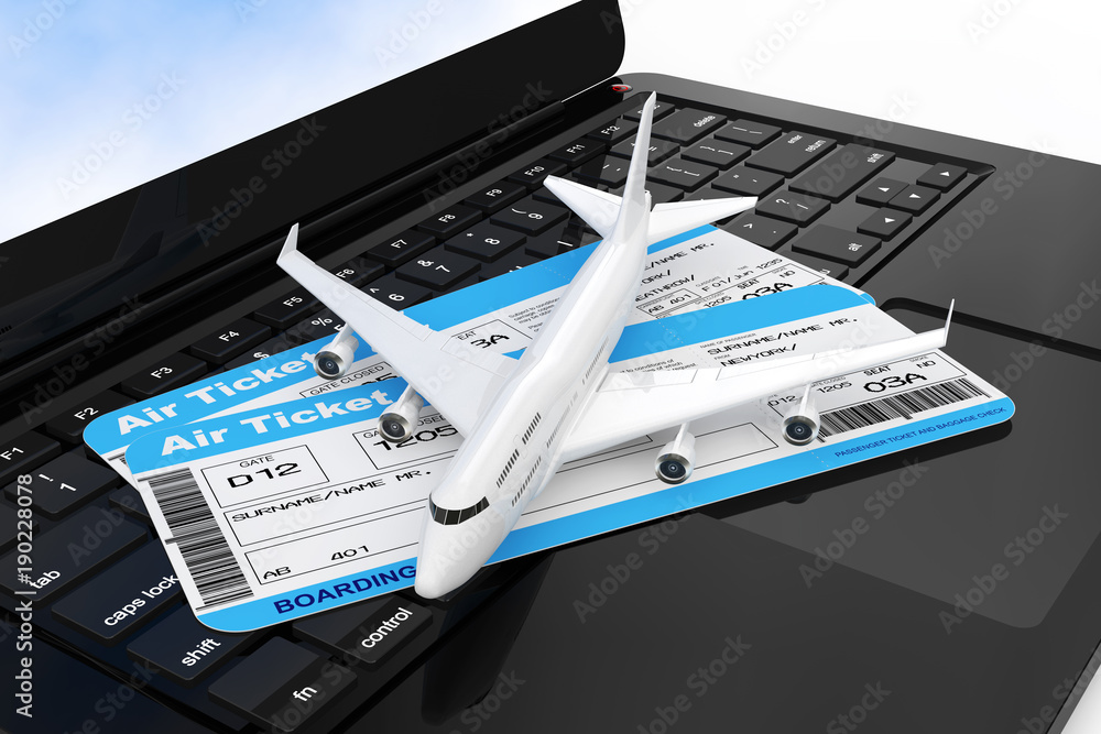Leinwandbilder white jet passenger's airplane with airline boarding pass tickets over modern laptop computer keyboa