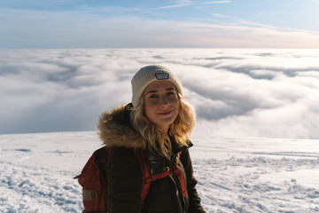 Fototapeta na wymiar Girl hiking on snow in Slovak mountains during sunset in winter