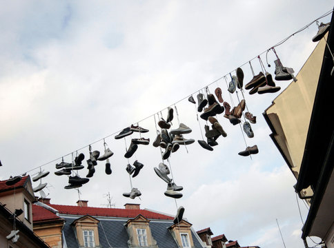 lota of hanging shoes from a line