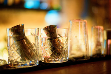 Alcohol bar, cocktail glass on bar counter, cocktail glass in a bar, Drinking cocktail in bar, cocktail in the glass with straws, Fresh drink coctail on a color background