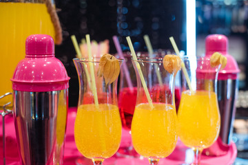 Alcohol bar, cocktail glass on bar counter, cocktail glass in a bar, Drinking cocktail in bar, cocktail in the glass with straws, Fresh drink coctail on a color background