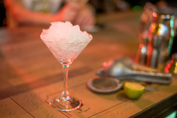 Alcohol bar, cocktail glass on bar counter, cocktail glass in a bar, Drinking cocktail in bar, cocktail in the glass with straws, Fresh drink coctail on a color background