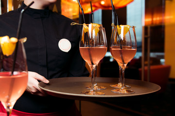 Alcohol bar, cocktail glass on bar counter, cocktail glass in a bar, Drinking cocktail in bar, cocktail in the glass with straws, Fresh drink coctail on a color background