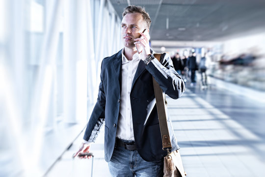 Businessman talking on phone in airport