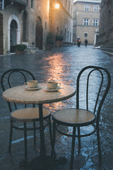 Rainy street cafe in old European town
