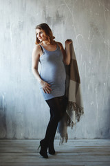 Happy pregnant woman in studio.