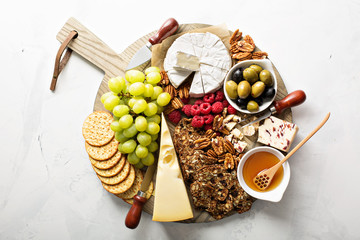 Cheese and snacks plate on white background