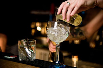 Alcohol bar, cocktail glass on bar counter, cocktail glass in a bar, Drinking cocktail in bar, cocktail in the glass with straws, Fresh drink coctail on a color background