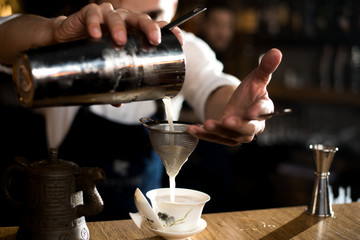 Fototapeta na wymiar Alcohol bar, cocktail glass on bar counter, cocktail glass in a bar, Drinking cocktail in bar, cocktail in the glass with straws, Fresh drink coctail on a color background