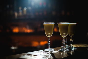 Alcohol bar, cocktail glass on bar counter, cocktail glass in a bar, Drinking cocktail in bar, cocktail in the glass with straws, Fresh drink coctail on a color background