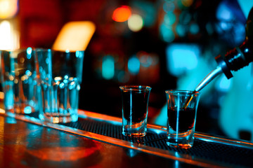 Fototapeta na wymiar Alcohol bar, cocktail glass on bar counter, cocktail glass in a bar, Drinking cocktail in bar, cocktail in the glass with straws, Fresh drink coctail on a color background