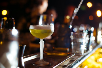 Alcohol bar, cocktail glass on bar counter, cocktail glass in a bar, Drinking cocktail in bar, cocktail in the glass with straws, Fresh drink coctail on a color background
