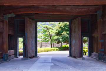 Large heavy doors that open into a Japanese garden.