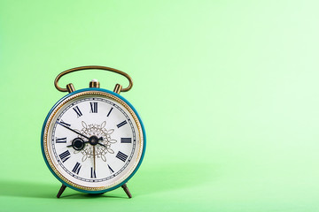 Old rusty clock on soft green background