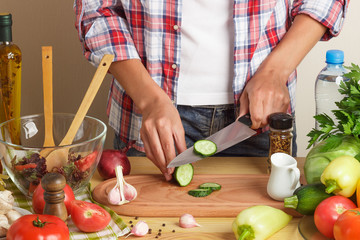 Woman is cooking at the kitchen