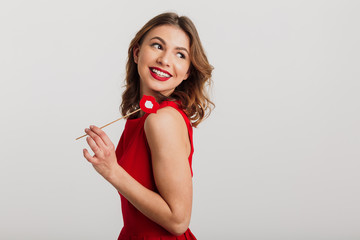 Portrait of a beautiful young woman dressed in red dress