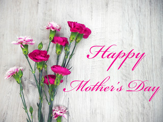 Flowers on a wooden clear background and Happy Mother's day