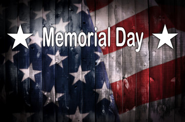 An American flag on wood with the words Memorial Day in white.