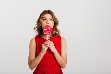 Portrait of a pretty young woman dressed in red dress