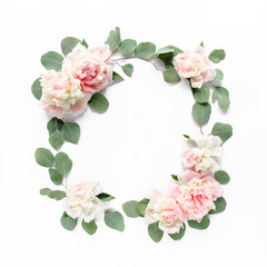 Floral round frame wreath made of pink and beige peonies flower buds, eucalyptus branches and...