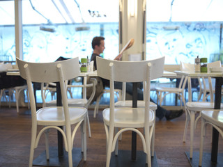 restaurant with white wood chairs and large windows