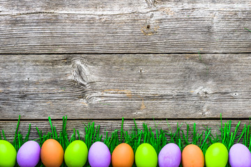 Colorful eggs on grass, easter background, spring festive decoration