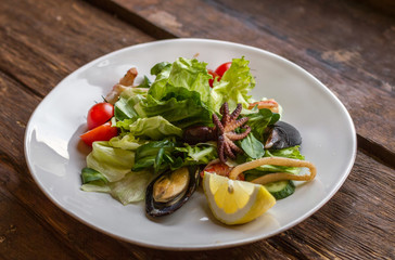 Tasty salad with seafood on a white plate