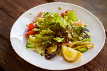 Tasty salad with seafood on a white plate
