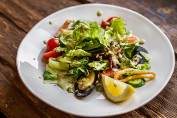 Tasty salad with seafood on a white plate