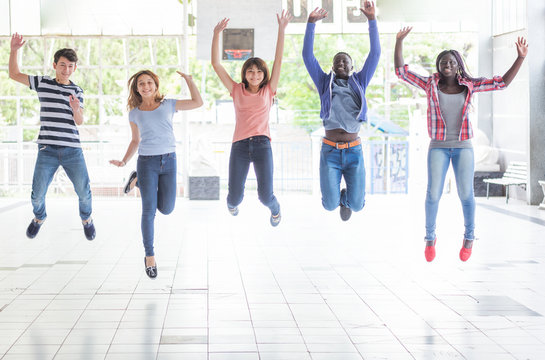 Mixed Race Teenagers Happy Jumping