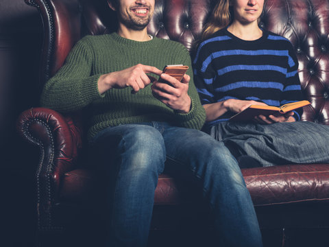 Happy man and woman on sofa