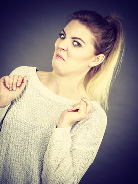 Disgusted woman having funny face expression
