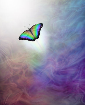 Metaphor for passing over to the afterlife - soul release - lone rainbow coloured butterfly moving up towards the white light away from multicoloured energy flowing background