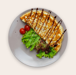 Vegetable omelette on plate isolated on white background