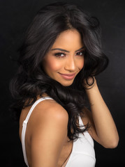 Beautiful woman with long dark hair wearing white dress
