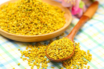 Bee pollen in wooden plate and spoon