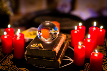 Crystal ball to prophesy or esoteric clairvoyance during a Seance in the candle light