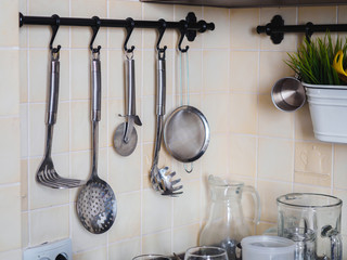 Kitchen metal chrome tools on the rail
