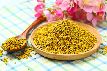Bee pollen in wooden plate and spoon