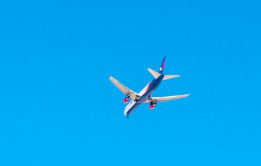 airplane flying against the blue sky