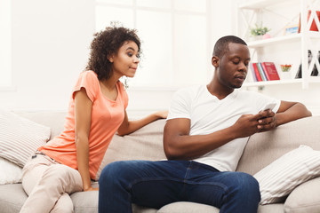 Young black couple making peace after quarreling at home