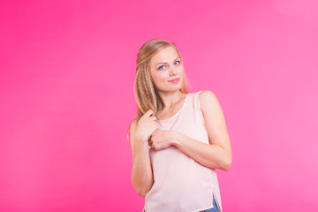Fashion blonde over pink background. Woman portrait.