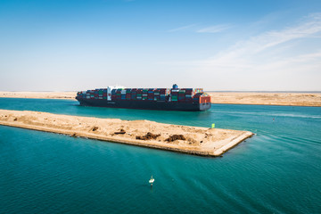 Container cargo ship sailing on Suez Canal.