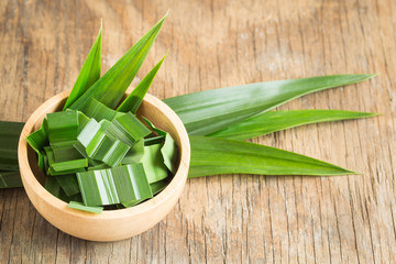 Fresh green pandan in a wooden bowl on wood table,pandan leaves on old wood background