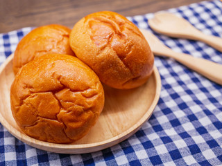 Breads in wooden plate on wooden background.Food concept