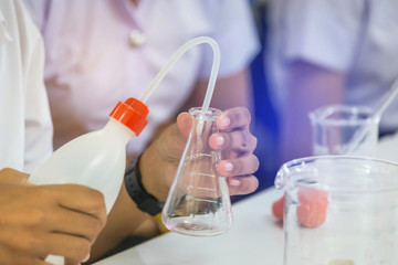 scientist hand holding flask equipment for research experiments in science laboratory