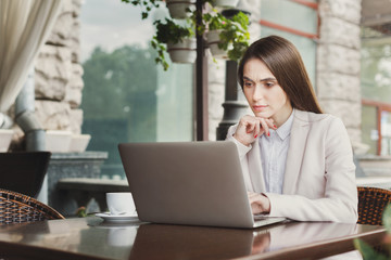 Young businesswoman outdoors working with laptop