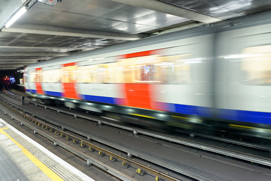 LONDON - SEPTEMBER 26, 2016: Train speeds up in city subway. The system has 270 stations and 250 miles of tracks
