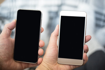 Two people hands holding mobile phones