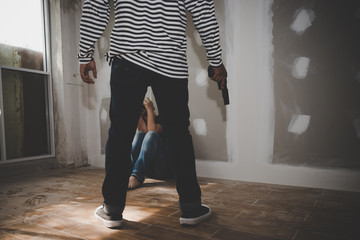 The girl was stripped by thieves in black and white shirt with a gun in hand at abandoned house.